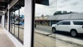 Reflections of traffic in a window retail strip malls