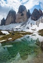 Reflections of Tre Cime Drei Zinnen mountain in the alpine lake, Italy