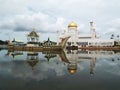 Reflections in the water of the boat and the Mosque of Sultan Omar Ali Saifuddin in Brunei