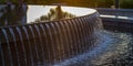 Reflections on the water of a fountain at sunset