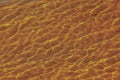 Reflections on the water surface in the river. Background of corrugated pattern of clean water sand. View from above. Abstract Royalty Free Stock Photo