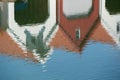 Reflections of white and red boat houses in water.. Royalty Free Stock Photo