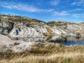 Reflections of the white sandstone cliffs at the Blue Lake at St Bathans in New Zealand