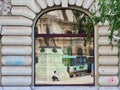 Reflections in Window of Older Style Bucharest City Building, Romania