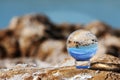 Reflective ball with sea and rocks