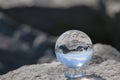 Reflective ball with sky and rocks
