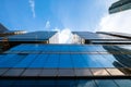 Reflective blue glass facade modern skyscraper office building with blue sky in economy financial business district Royalty Free Stock Photo