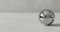 Reflective chrome sphere on industrial concrete floor Royalty Free Stock Photo