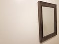 Mirror in wood frame on white wall Royalty Free Stock Photo