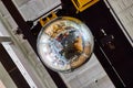 Reflective large disco ball on ceiling of old building Royalty Free Stock Photo