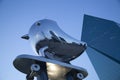 Reflective metal sculpture bird and buildings