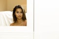 Reflective Portrait of young woman mixed race face in mirror Royalty Free Stock Photo