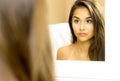 Reflective Portrait of young woman mixed race face in mirror Royalty Free Stock Photo