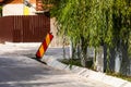 Reflective red and white striped warning road sign isolated in a working area