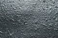 Reflective surface of raggy concrete wall. Dark gray grunge texture with metallic gloss. Shiny gray wall background. The grey roug Royalty Free Stock Photo