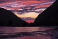 Reflectons of sunset light with rain drops on background of sunset with mountain silhoettes.