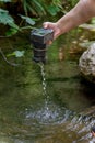 man pulls his reflex camera out of the river flooded with water Royalty Free Stock Photo