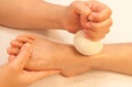 Reflexology foot massage by ball herb Royalty Free Stock Photo