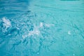 Blurred clear turquoise water in a pool for swimming and diving