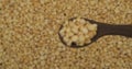 Refocusing from a spoonful of grains onto a background of peas grains. Selective focus.