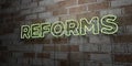 REFORMS - Glowing Neon Sign on stonework wall - 3D rendered royalty free stock illustration