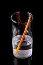 Refraction of Yellow Pencil in Glass of Water Royalty Free Stock Photo