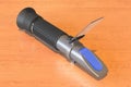 Refractometer on the wooden table. 3D rendering Royalty Free Stock Photo