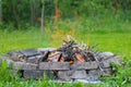 Refractory brick fireplace in focus and blurry bonfire in the background