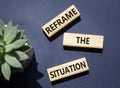 Reframe the situation symbol. Concept words Reframe the situation on wooden blocks. Beautiful deep blue background with succulent Royalty Free Stock Photo