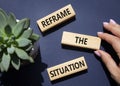 Reframe the situation symbol. Concept words Reframe the situation on wooden blocks. Beautiful deep blue background with succulent Royalty Free Stock Photo