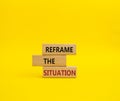Reframe the situation symbol. Concept words Reframe the situation on wooden blocks. Beautiful yellow background. Business concept Royalty Free Stock Photo