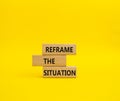Reframe the situation symbol. Concept words Reframe the situation on wooden blocks. Beautiful yellow background. Business concept Royalty Free Stock Photo