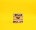 Reframe the situation symbol. Concept words Reframe the situation on wooden blocks. Beautiful yellow background. Business concept Royalty Free Stock Photo