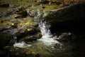 Refreshed small brook river stream flowing over gravel bed with stunning mountain scenery in background. Concept Royalty Free Stock Photo