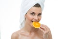 Refreshed woman eating orange