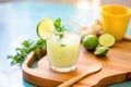 refreshing agua fresca in a glass with sliced cucumbers