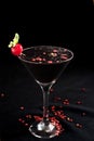 Refreshing alcoholic drink with berries, ice vodka and gin, absinthe lemon peel served in glass cup on the counter on black Royalty Free Stock Photo