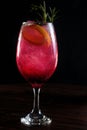 refreshing alcoholic drink with berries, ice vodka and gin, lemon peel served in glass cup on the counter on blurred background Royalty Free Stock Photo