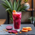 Refreshing beetroot and orange juice in glass with vegetables on slate table Royalty Free Stock Photo