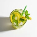 A refreshing beverage is served in a clear glass filled with ice cubes, lemon and lime Royalty Free Stock Photo
