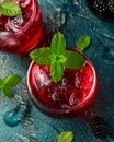 Refreshing Blackberry cocktail with ice and mint on rustic background