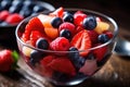 Refreshing bowl of fruit salad filled with juicy strawberries and vibrant blueberries