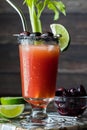 A refreshing Caesar cocktail garnished with black olives, lime and celery. Royalty Free Stock Photo