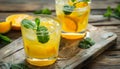 Refreshing citrus cocktail with mint leaf on wooden table