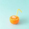 Refreshing citrus fruit juicy orange with ice and pinned drinking straw on a blue summer background. Summer juice concept Royalty Free Stock Photo