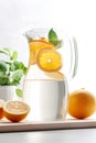 Refreshing Citrus Infusion: Water Jug with Oranges. Royalty Free Stock Photo