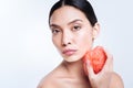 Beautiful woman holding bath sponge near her neck Royalty Free Stock Photo