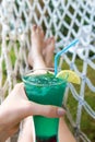 Refreshing cocktail in female hand, vacation time Royalty Free Stock Photo