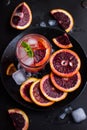 Refreshing cocktail with red blood orange, ice and mint