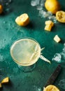 Citrus cocktail on a messy teal table full of ice and lemons Royalty Free Stock Photo